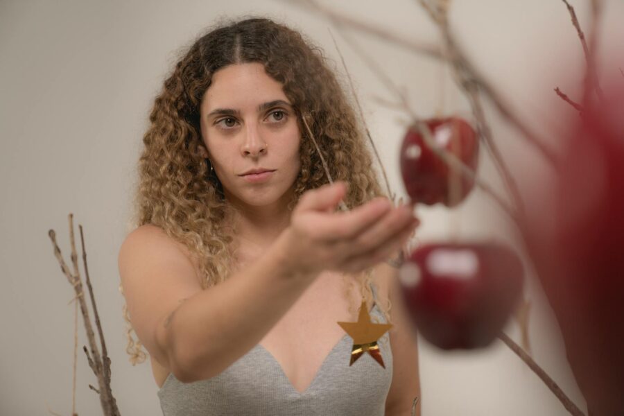 woman touching a red apple
